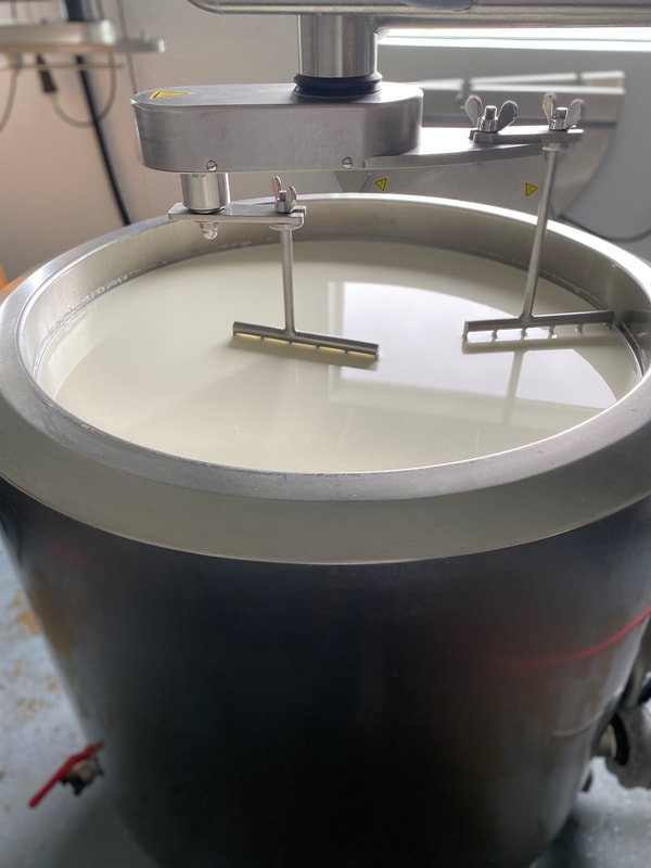 Image contains a full vat of pasteurized cows milk. 