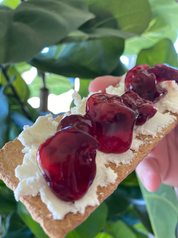 Image contains Original fresh cheese spread on a graham cracker topped with cherry filling. 